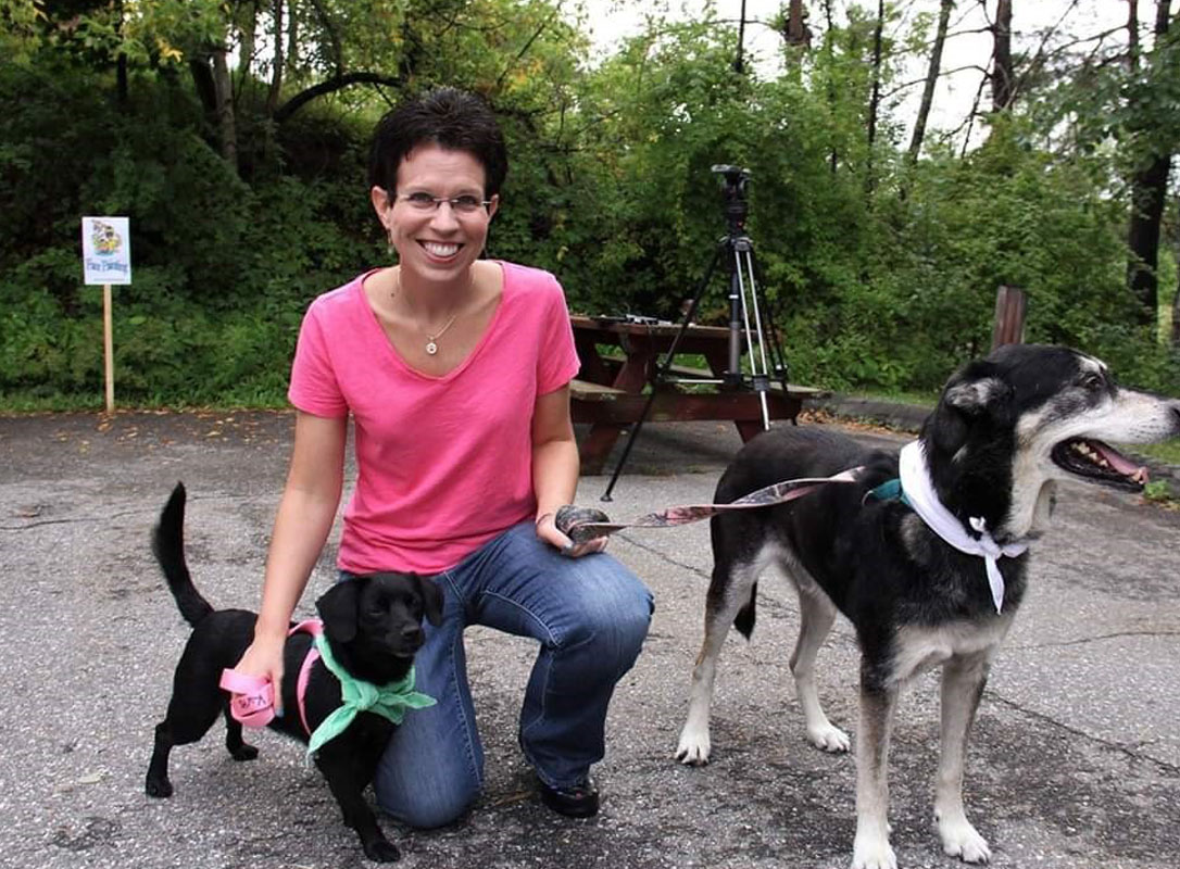 KSB's Erin B. posing with two dogs for a photo
