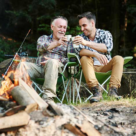 Two guys sitting in camping chairs.