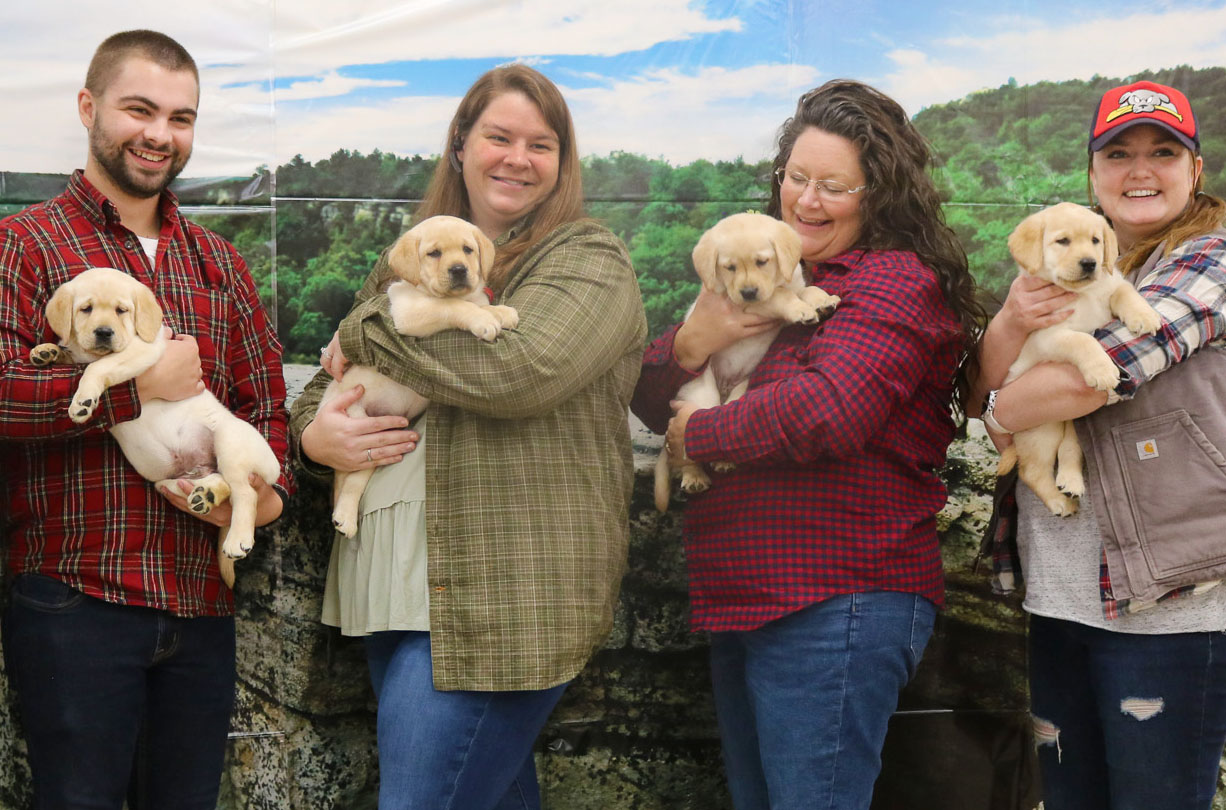 KSB's Nick, Leah, Amanda, and Dana pose for a photo with puppies