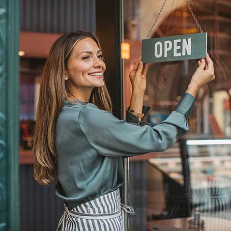 Woman with business open sign.