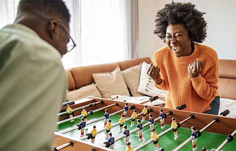 Two people playing foosball. 