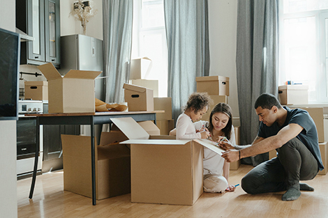 Family with packing boxes surrounding them